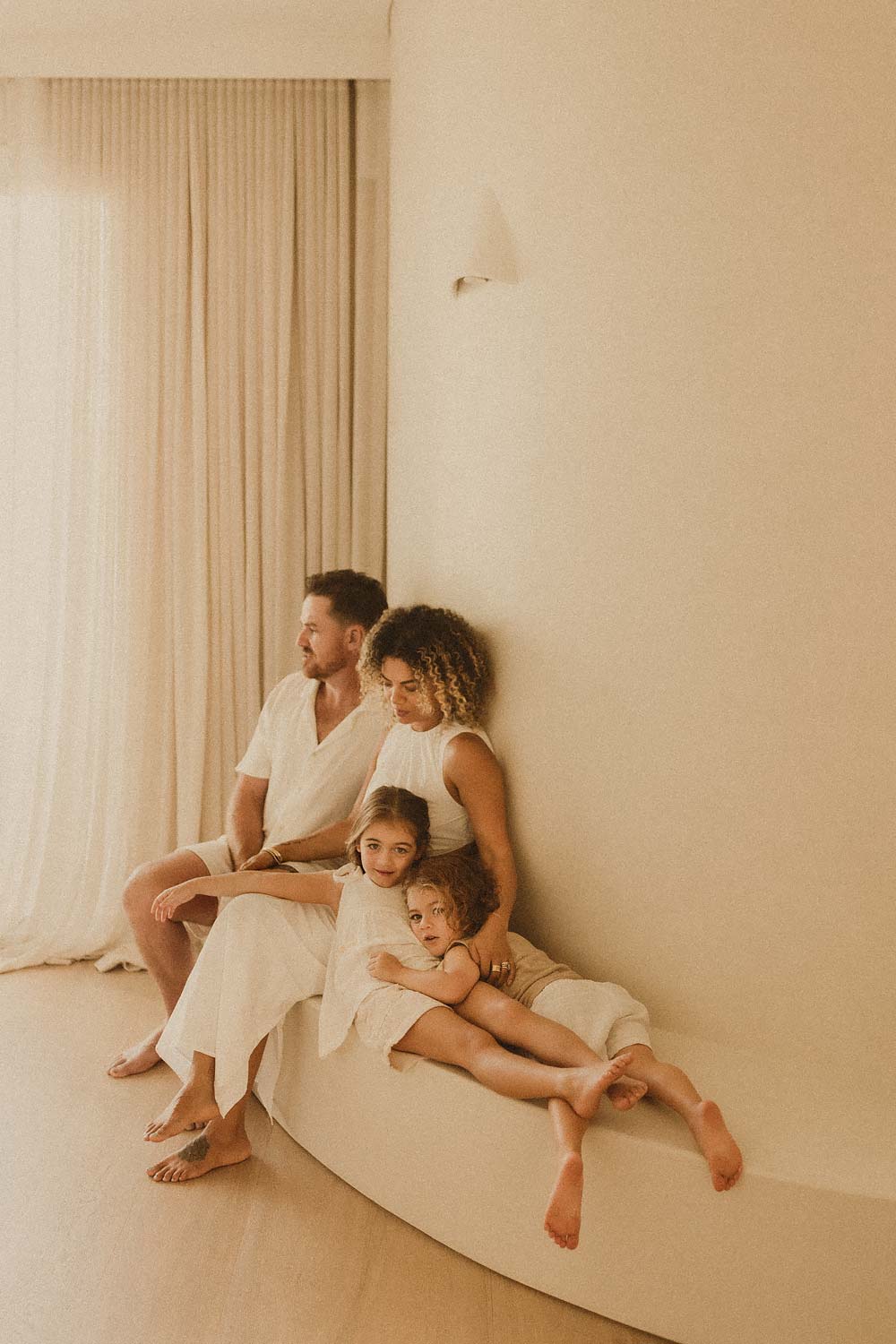 Family-photography-sydney-mum-dad-and-who-young-children-relaxing-in-very-chic-minimalist-home