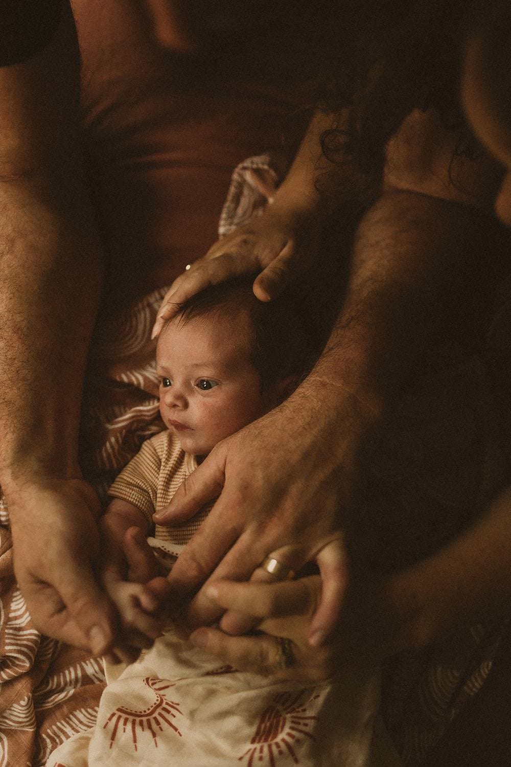 Newborn-photography-sydney-mum-dad-hands-around-baby