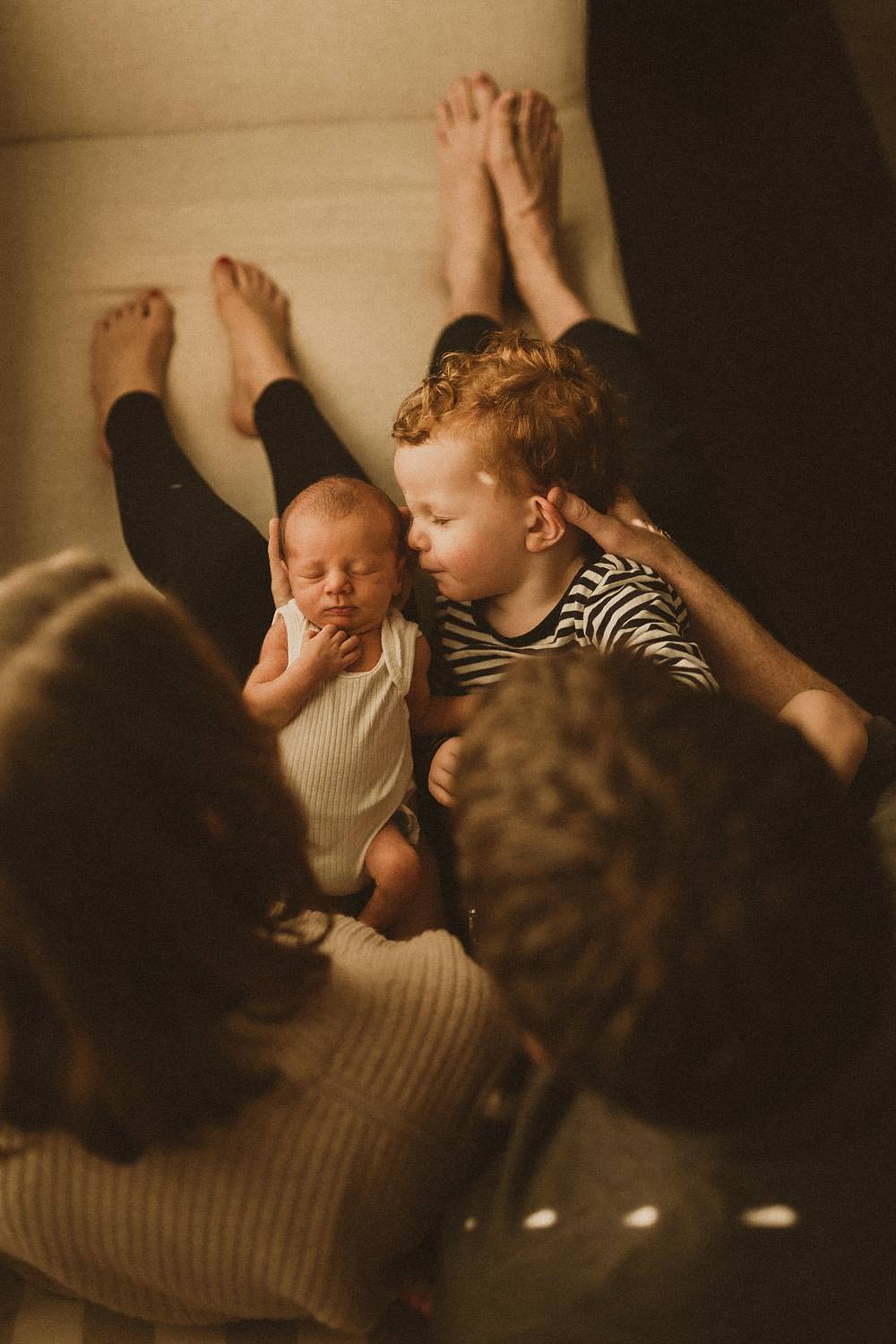Newborn-sibling-photography-sydney-big-brother-smells-newborn
