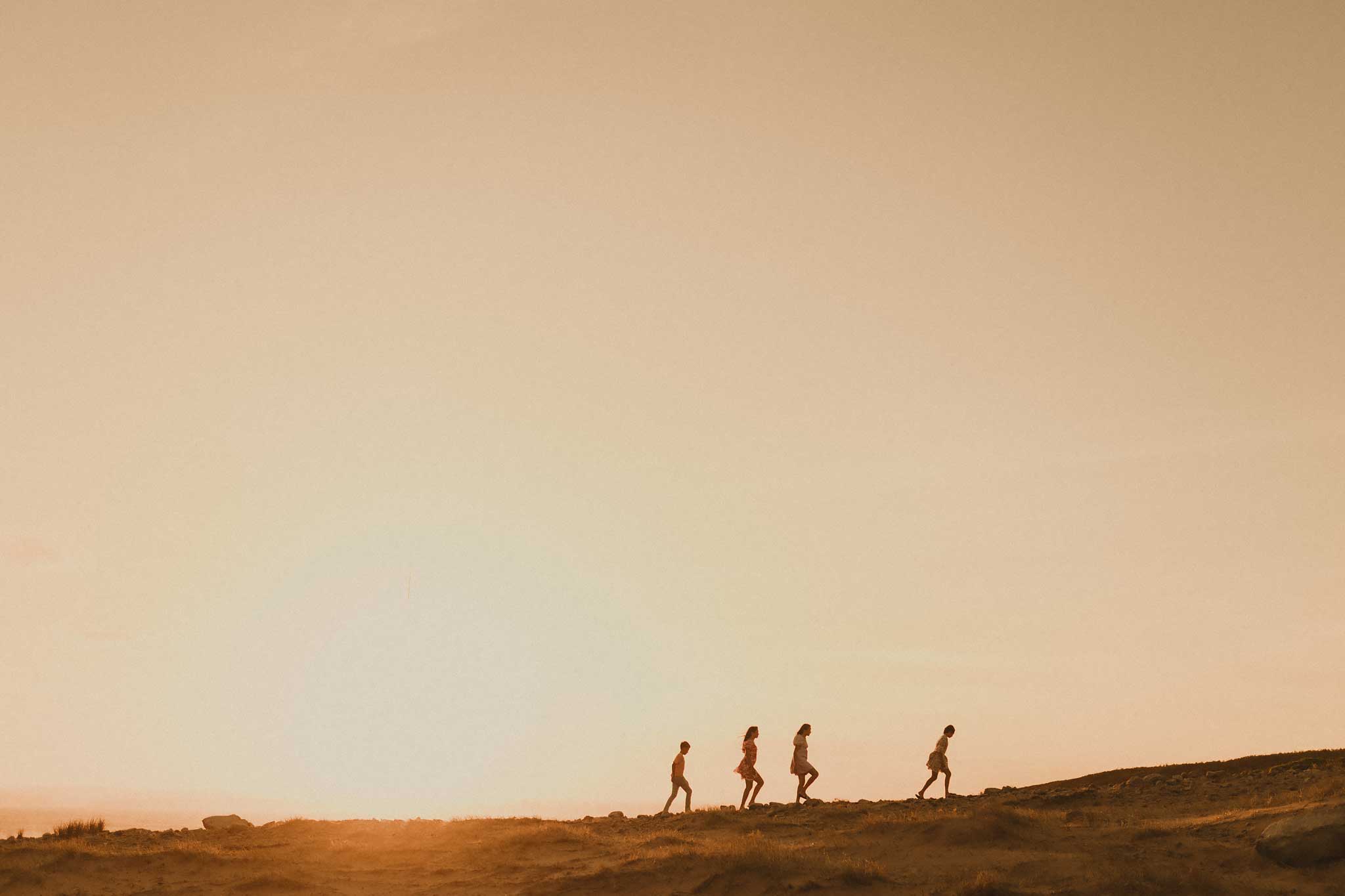 four-kids-walking-up-a-hill-together