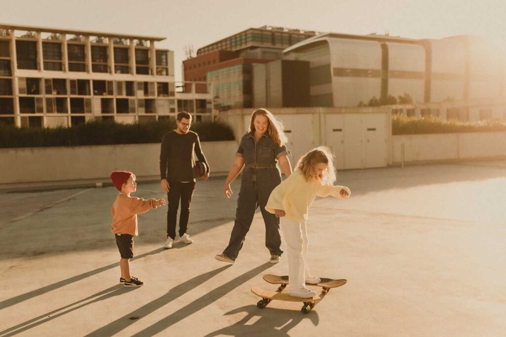 Family skateboarding together on a rooftop during a relaxed Inner West family photography session
